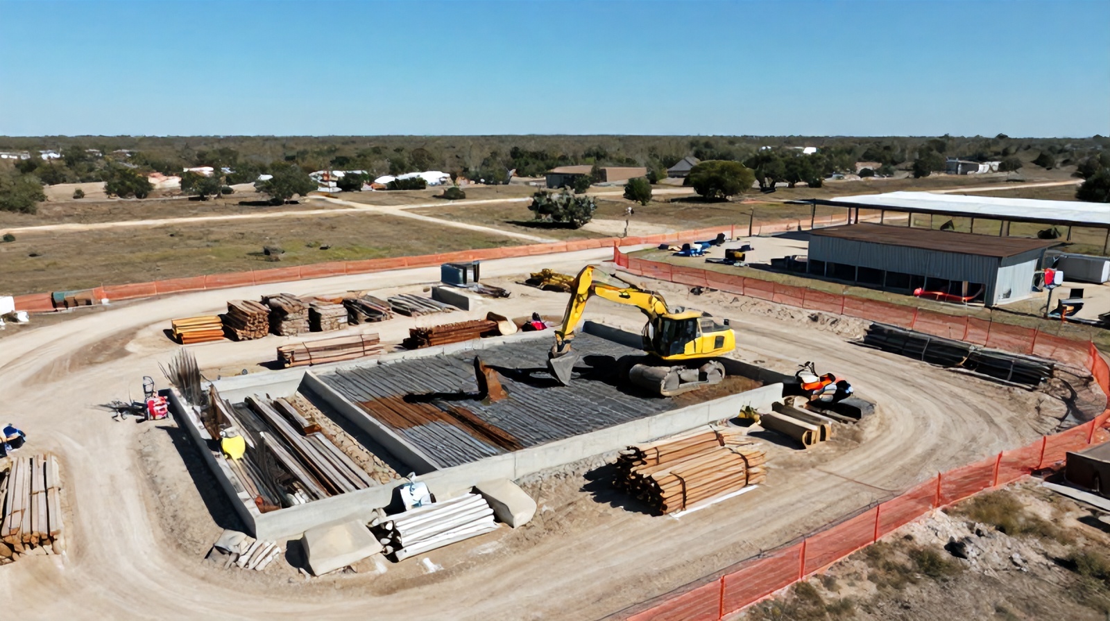 Close aerial view of construction equipment and foundation work at a Round Rock, Texas building site