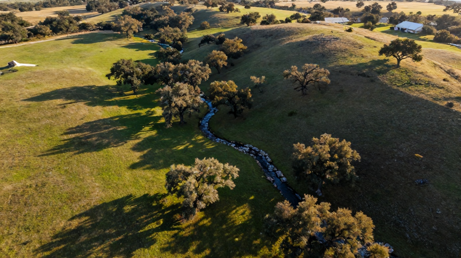 High-altitude aerial photograph of Texas Hill Country ranchland captured by a professional camera drone at golden hour