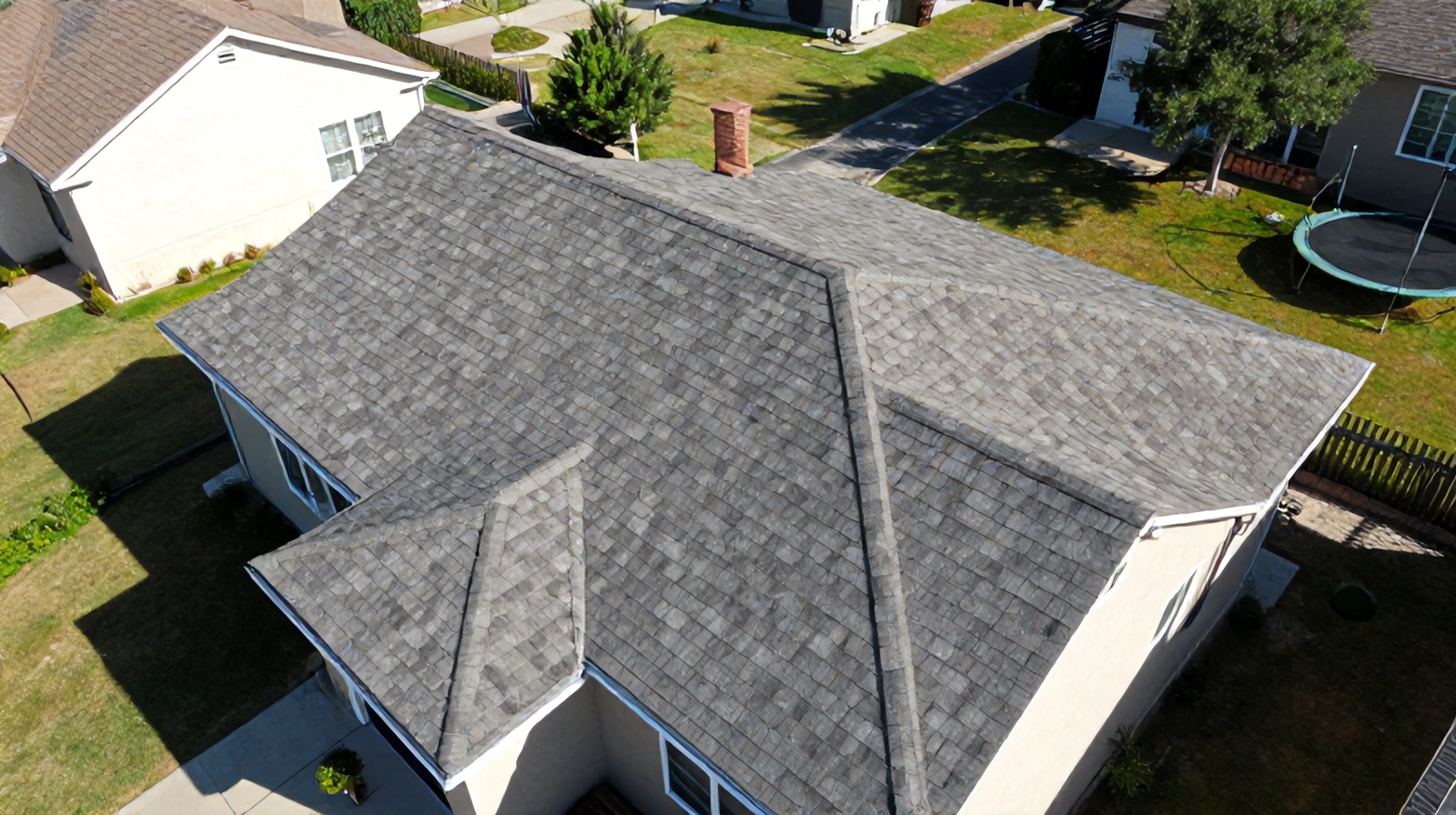 Close-up aerial drone shot of a residential rooftop used for roof inspection alongside real estate photography