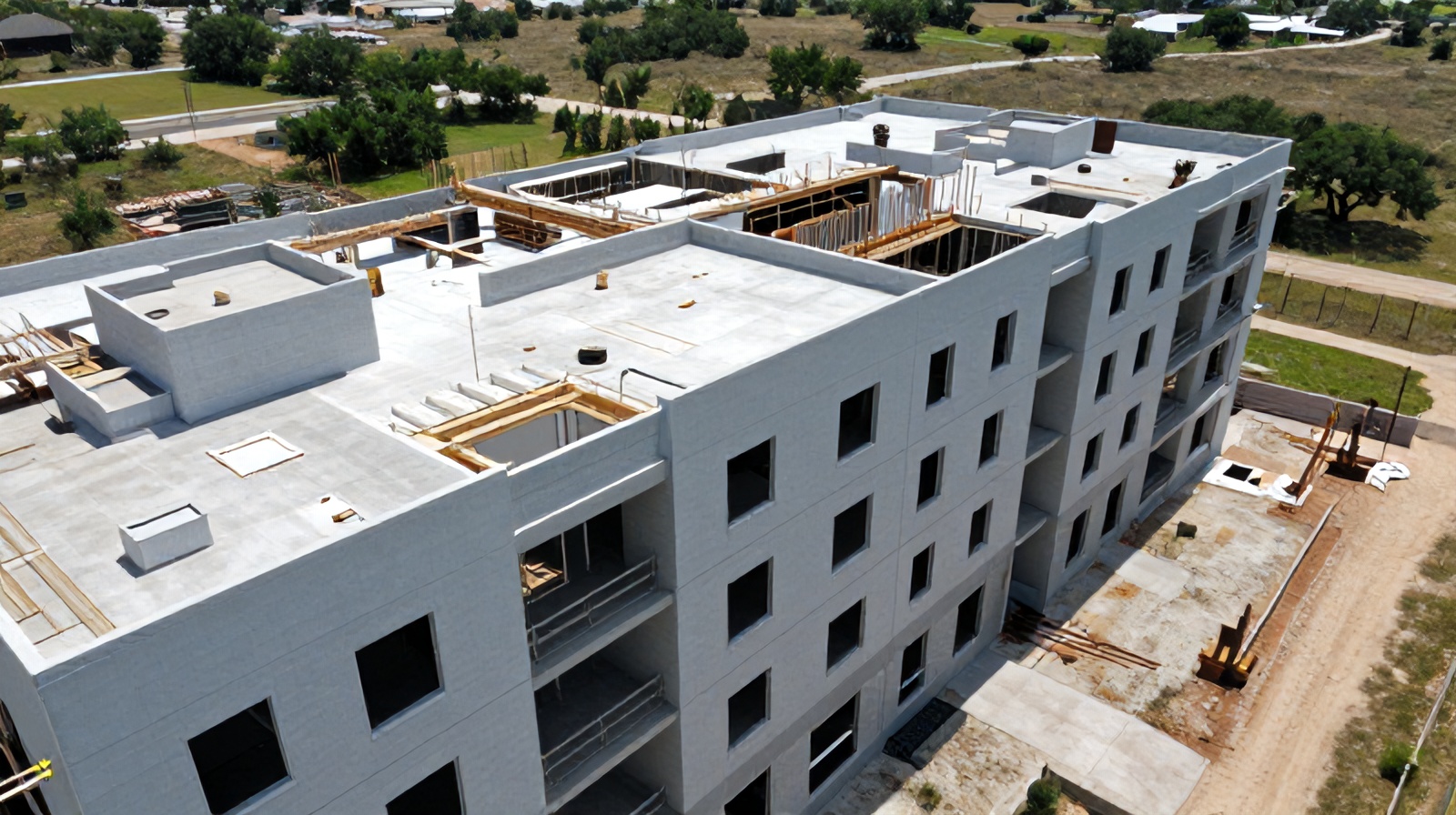 Oblique aerial close-up of a mid-construction building facade in Austin used for verifying as-built accuracy