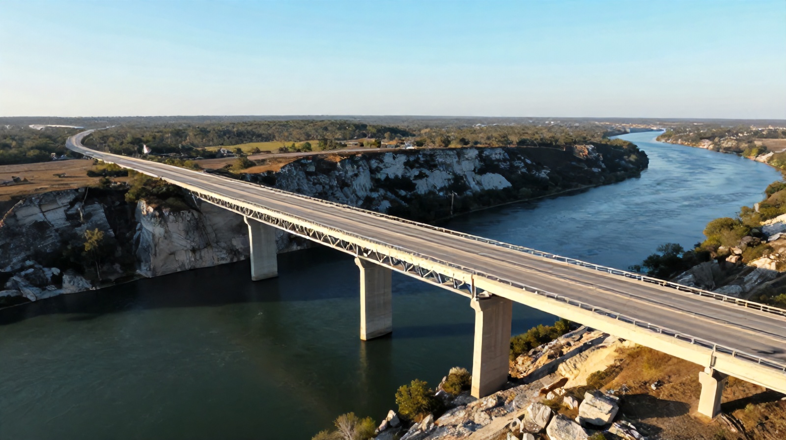 Aerial oblique view of a large highway bridge spanning a Texas river, illustrating drone bridge inspection services