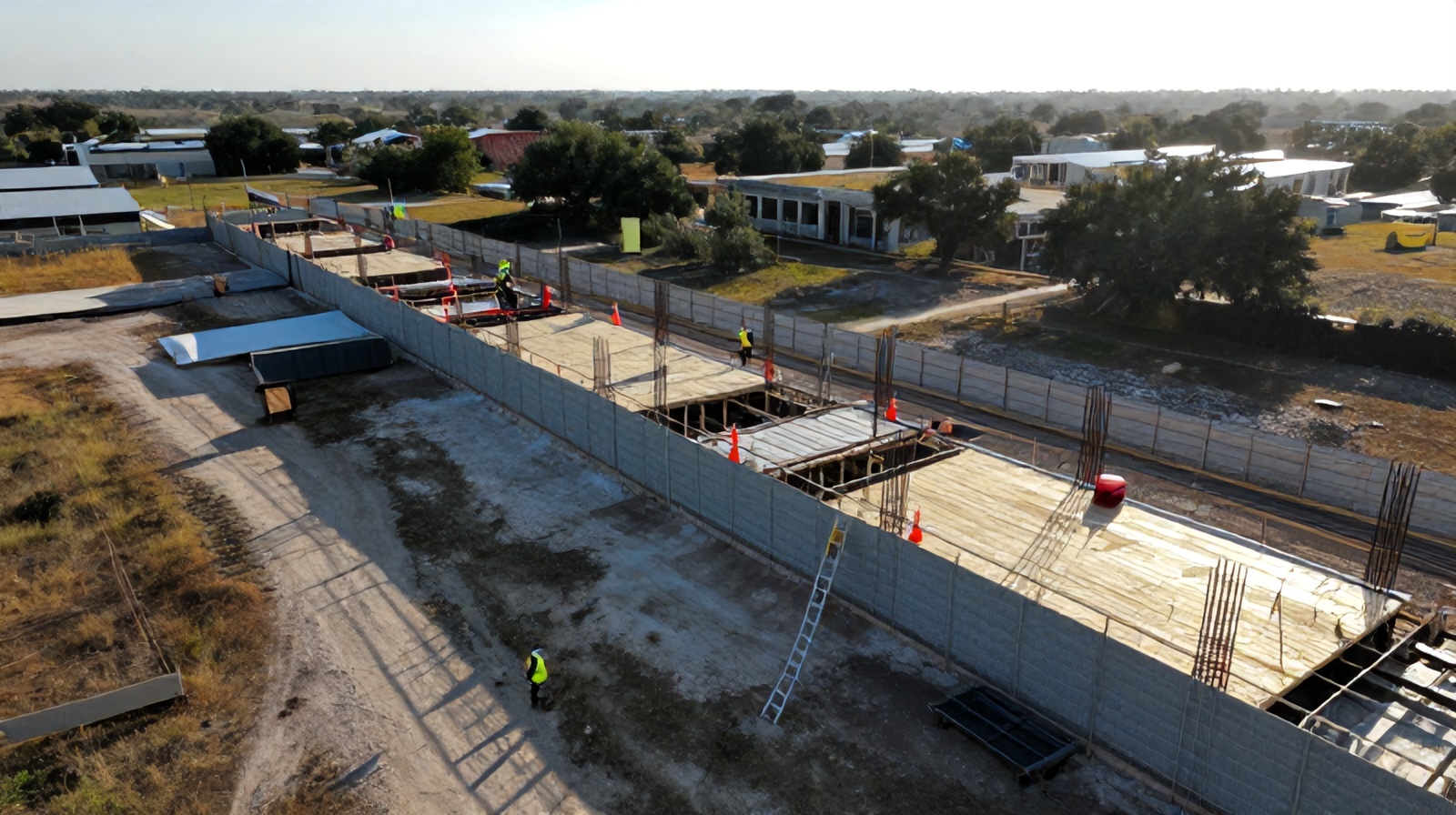 Close aerial oblique shot of a construction site edge highlighting fall hazard risks near unfinished flooring