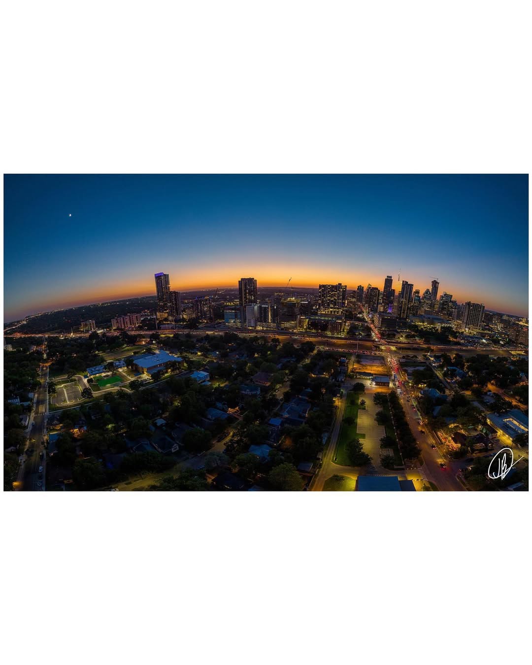 Aerial Showcase - Panoramic aerial view of city skyline at sunset with dramatic fisheye perspective