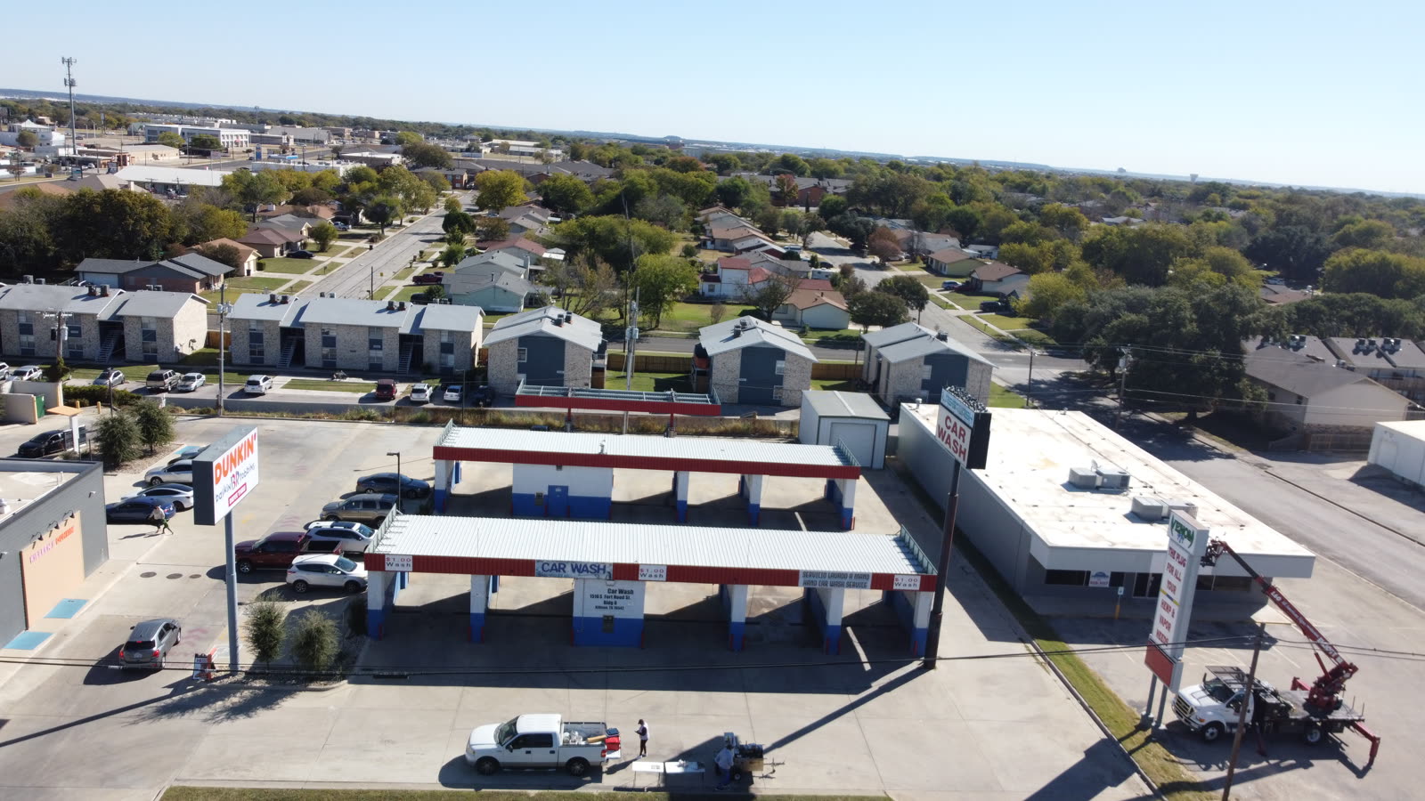 Aerial view of a large flat commercial roof with rooftop HVAC units