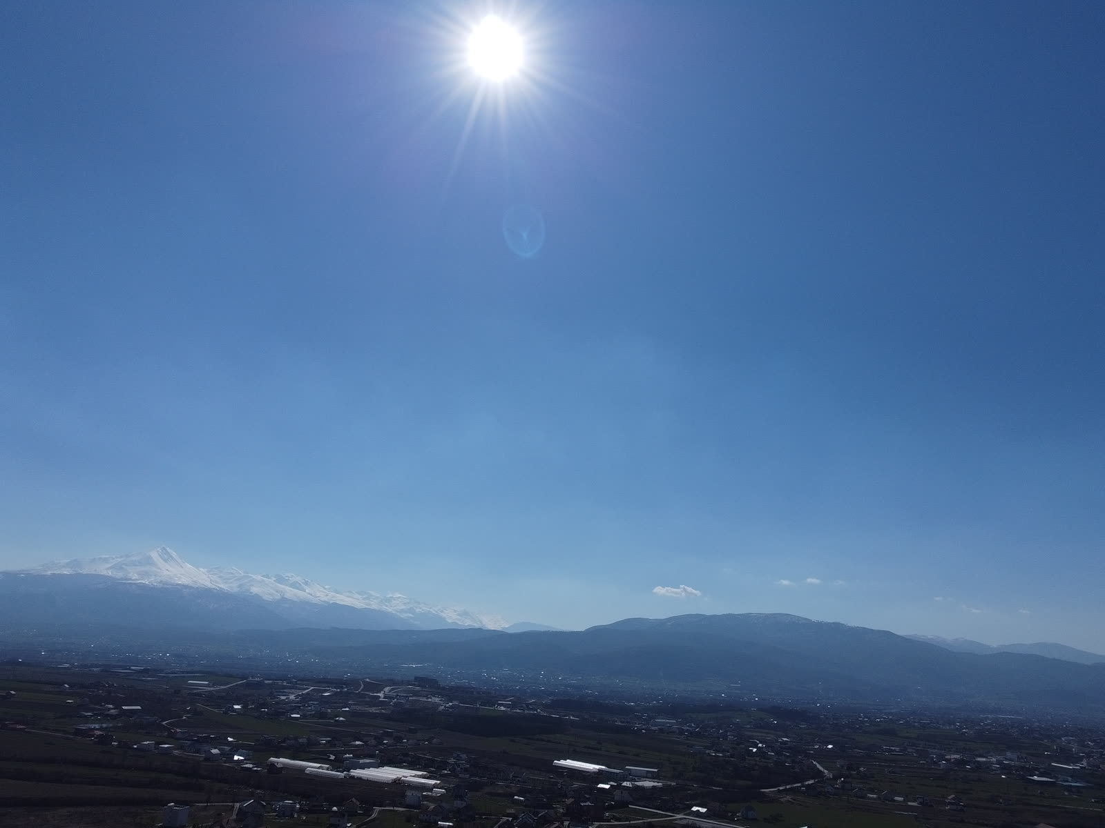 Cell tower rising against a clear sky, the type of structure inspected by drone