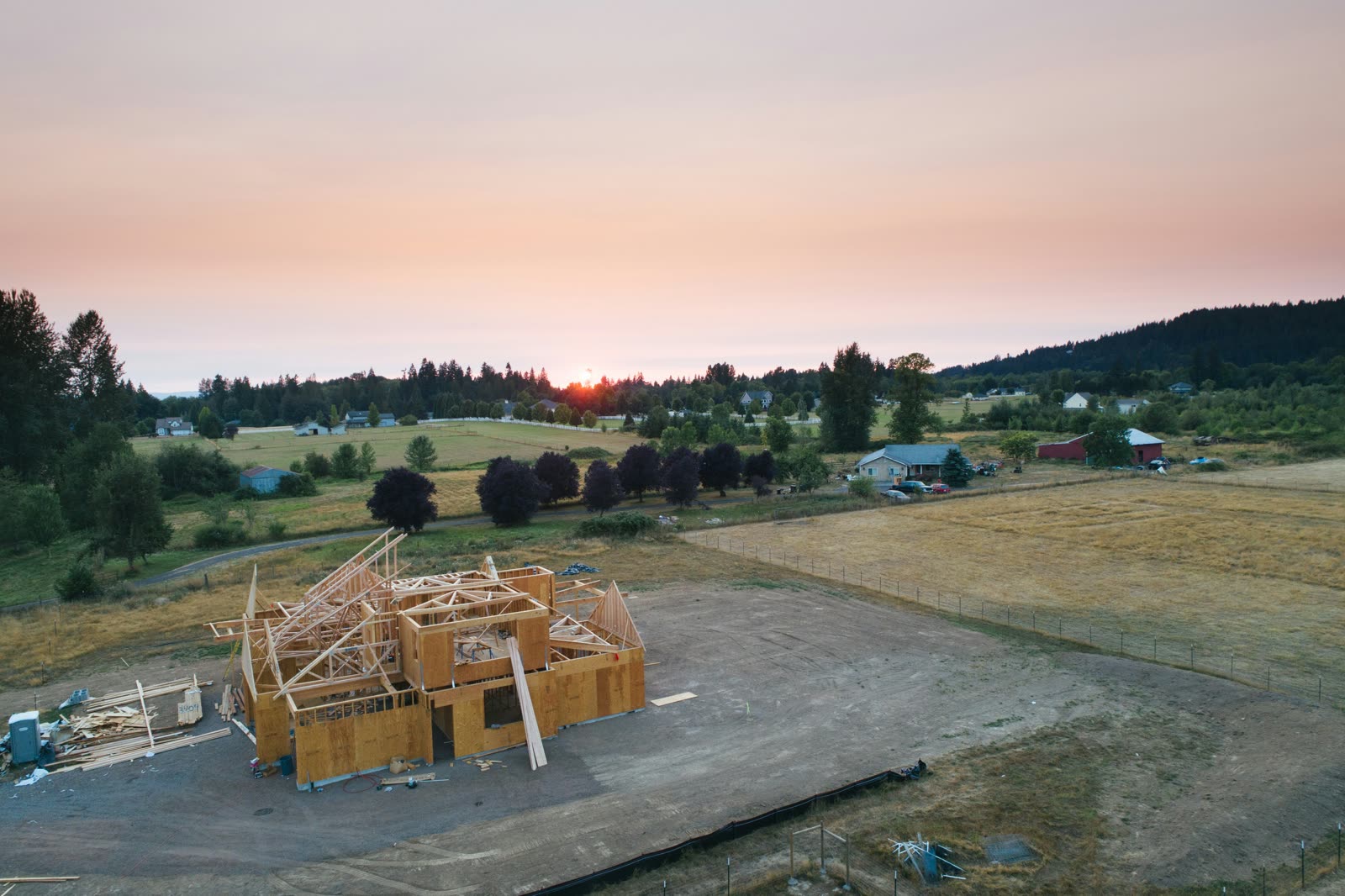 Aerial view of a new home build framed at sunset