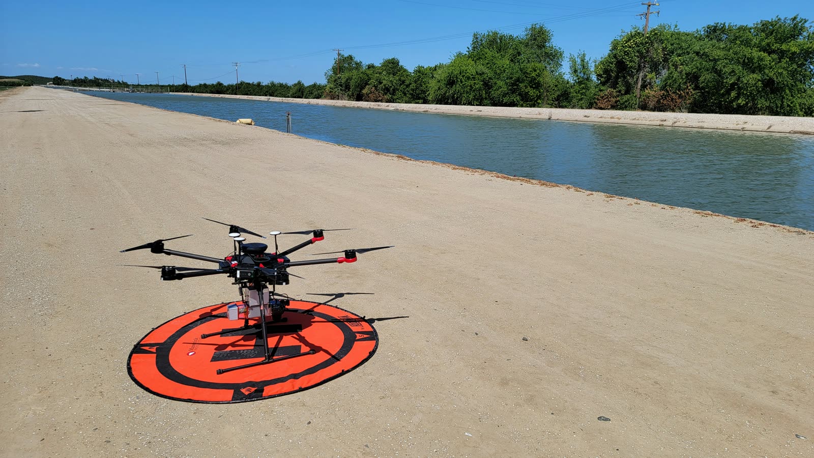 Survey drone staged beside a canal before an infrastructure mapping flight