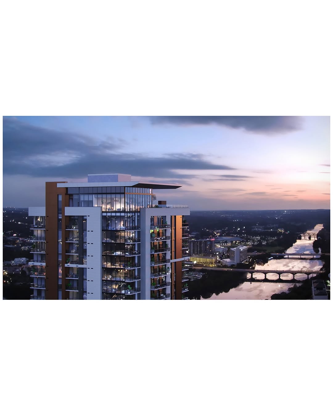 Urban Perspectives - Aerial drone view of a modern high-rise building at dusk with a river and cityscape in the background